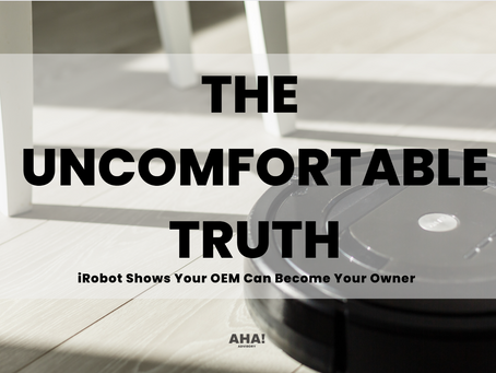 Robot vacuum on a bright floor under a chair, with text “The Uncomfortable Truth: iRobot Shows Your OEM Can Become Your Owner”.