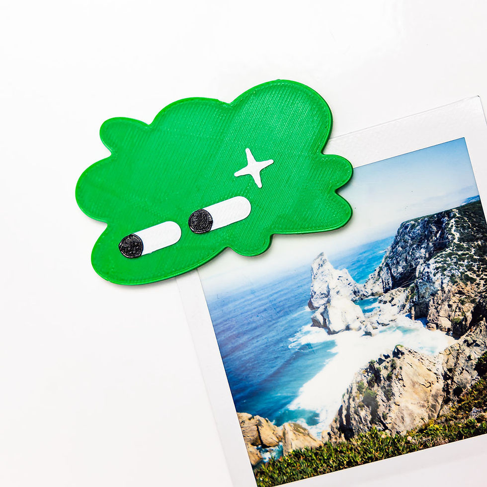funny green magnet on the fridge holding a picture, 3d printed design in a cloud shape, eco friendly magnets for the fridge