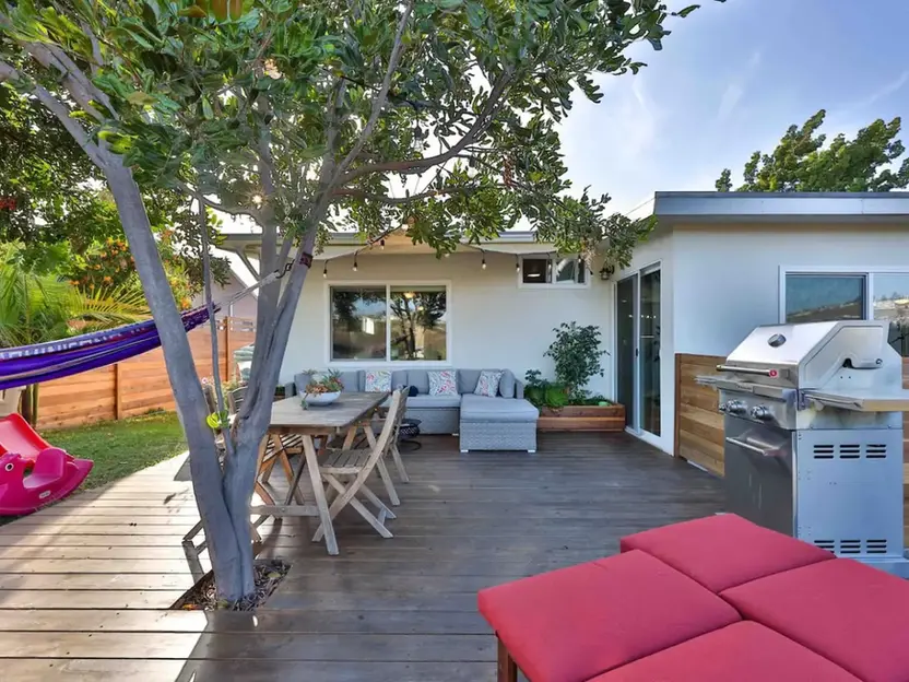 Patio with lounge, dining, and grill for boutique rentals