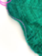 pink stitch holder on green fabric