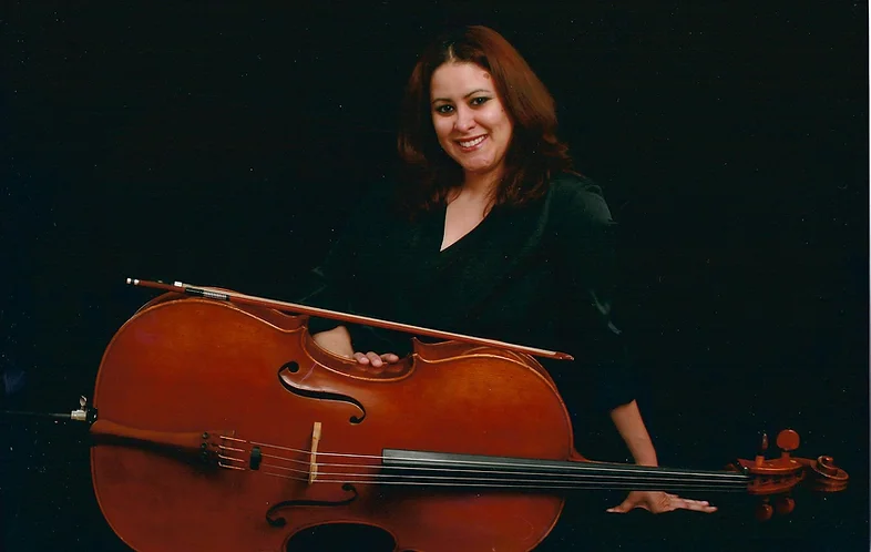 Ana Caban: Cello teacher posing with cello
