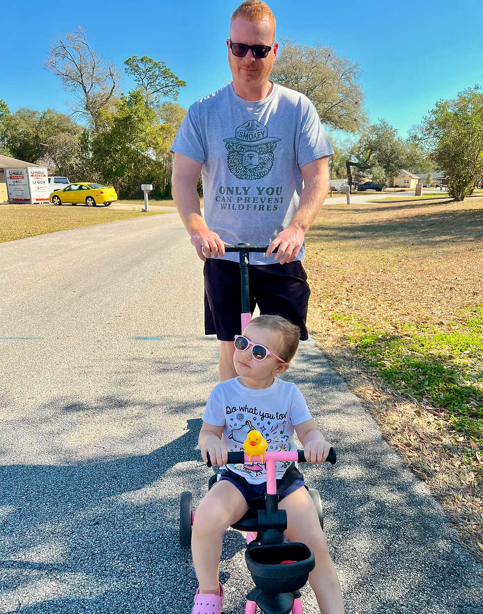 Stephen Gensel walking with his daughter on a neighborhood trail in Orange City, Florida.