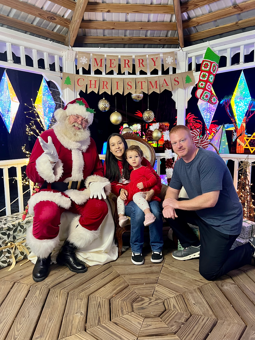 Stephen Gensel, his wife Daniela, and their daughter enjoying a community holiday event in Orange City, Florida.