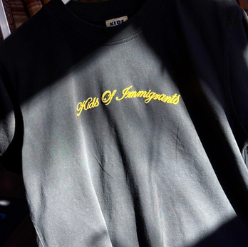 Kids of Immigrants black t-shirt with yellow screen print design