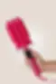 Thumbnail: Luxe + Willow Triple Barrel Waver in pink held in hand for glossy frizz-free beach wave styling.