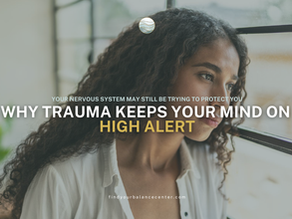 Person looking thoughtfully out a window, illustrating trauma-related hypervigilance and heightened awareness even in a safe environment.