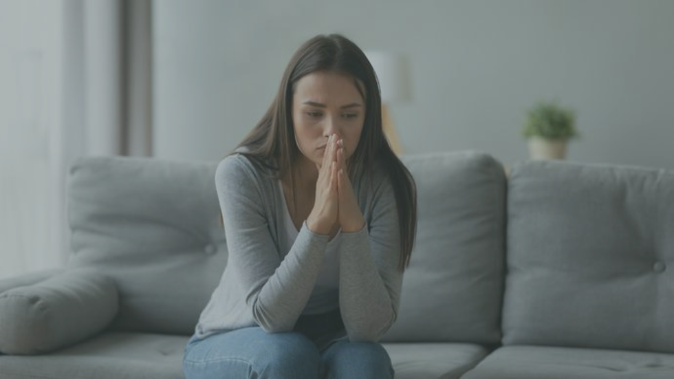Person feeling anxious and hesitant during a difficult conversation, reflecting common signs of conflict avoidance.