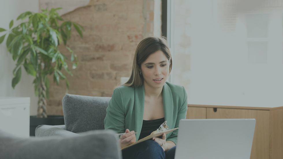 Latina woman attending a virtual therapy session from home while speaking with a therapist on a laptop.