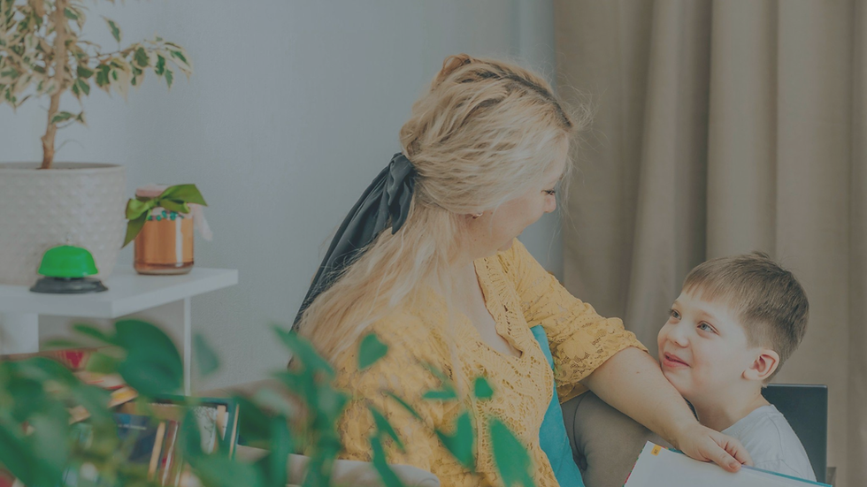 Mother sitting calmly with her child in a warm home environment, reflecting emotional presence, care, and connection.