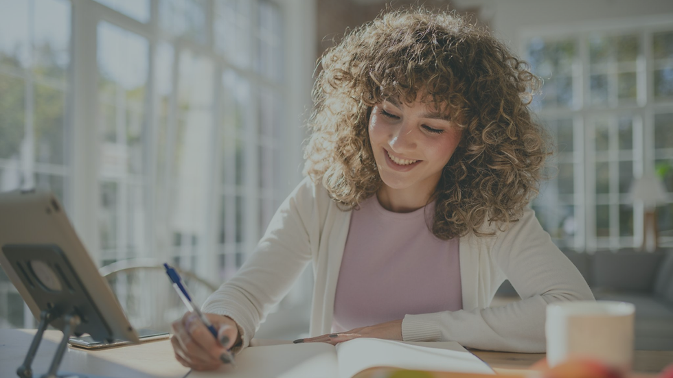 Person journaling quietly while reflecting on healing and emotional growth.