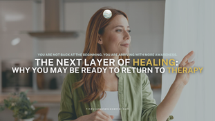 Woman standing by a window reflecting on personal growth and emotional healing.