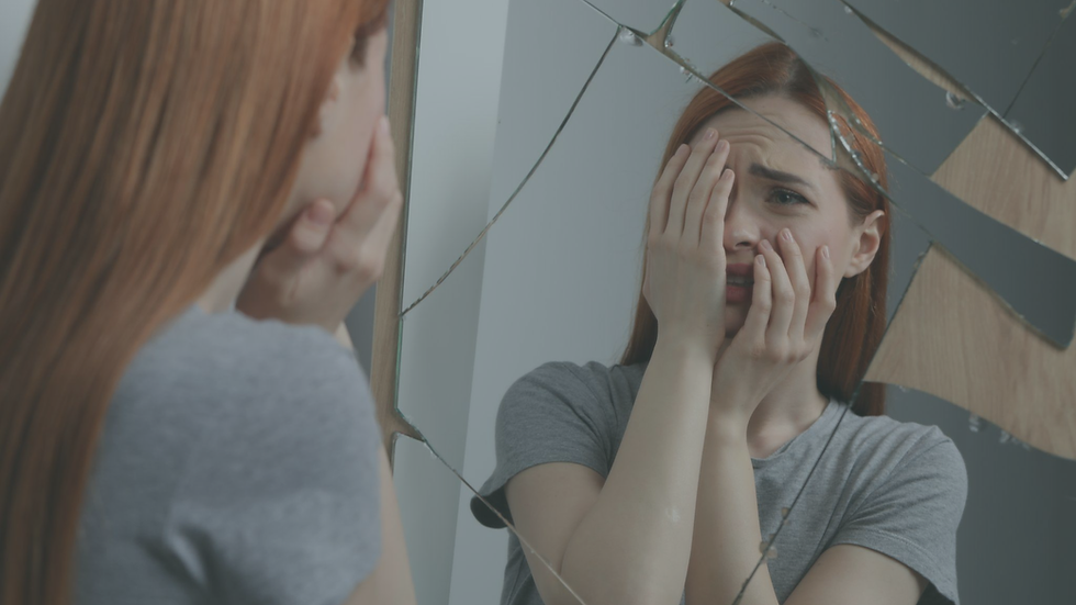 Adult reflecting quietly while struggling to understand the emotional impact of childhood experiences.
