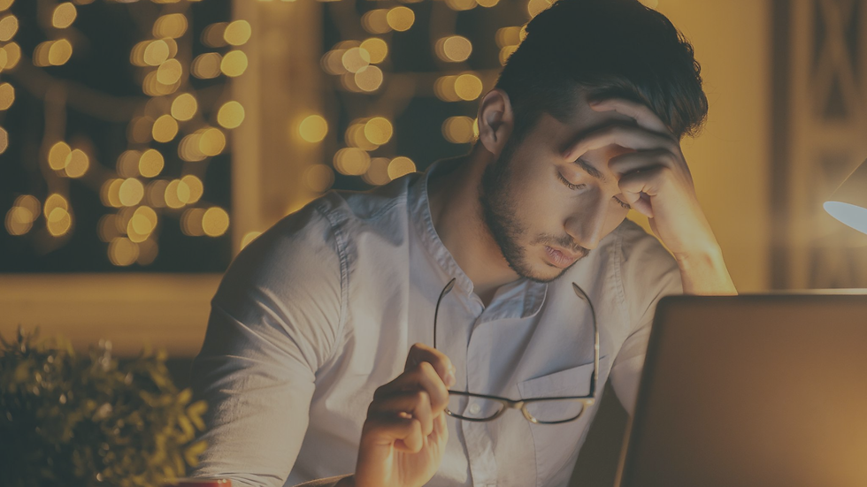 Person sitting alone looking emotionally exhausted and mentally overwhelmed as accumulated stress and emotional fatigue continue building over time.