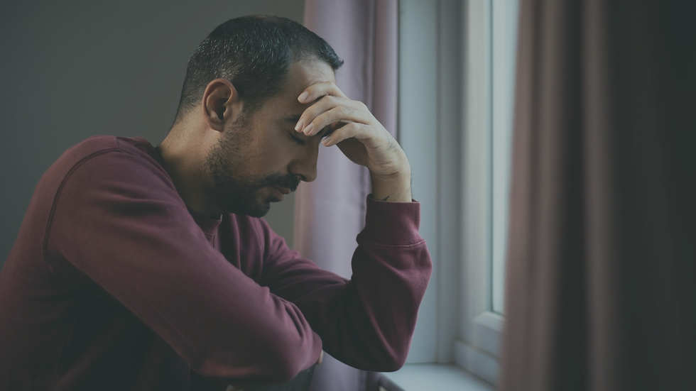 Man sitting quietly and withdrawn while experiencing a freeze response during overwhelming stress