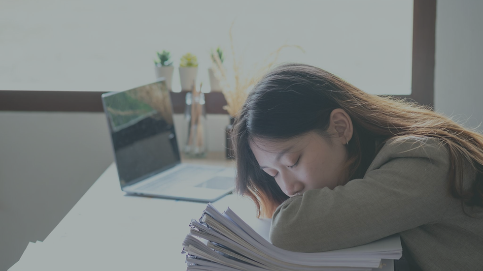 Employee sitting alone after work showing signs of burnout and exhaustion.