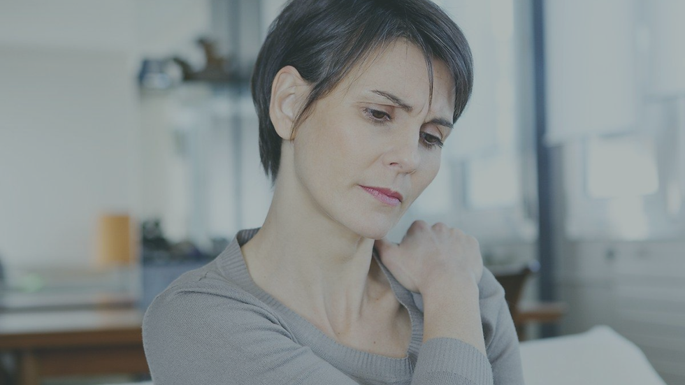 Person experiencing physical tension associated with chronic stress and nervous system activation.