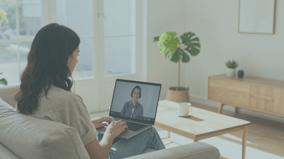Person participating in an online therapy session from home using a laptop, sitting in a bright and comfortable living room with natural light, representing accessible telehealth mental health support across California.