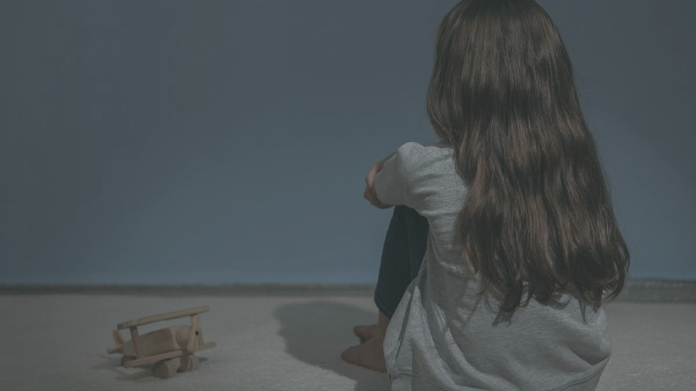 Child sitting alone while feeling emotionally unseen and unsupported despite having physical needs met.