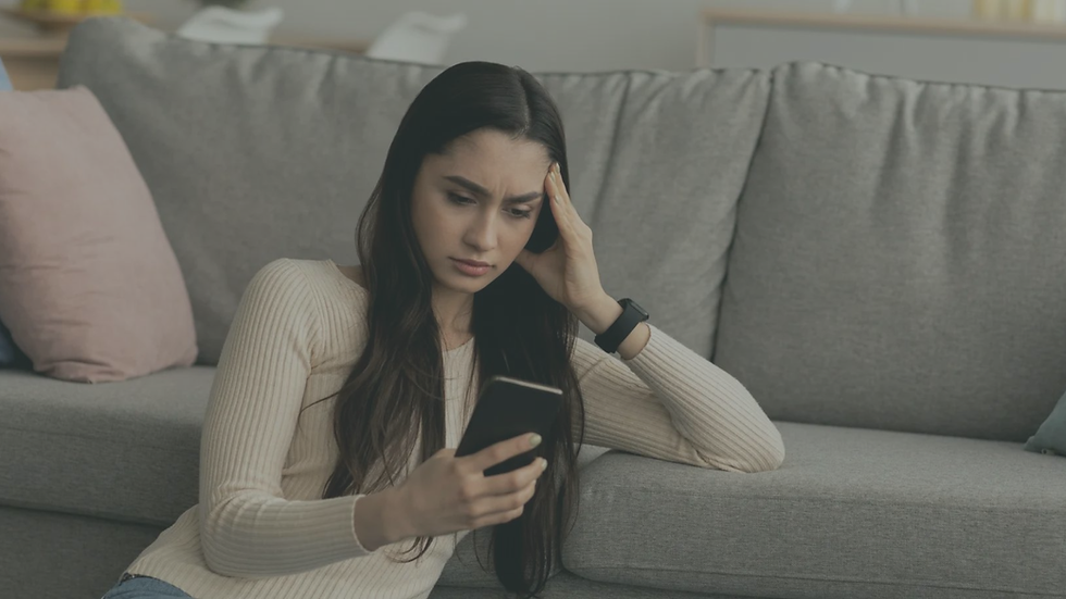 Person sitting alone while overthinking and seeking reassurance, illustrating anxiety, relationship insecurity, and repetitive worry patterns.