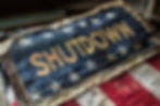 the word shutdown on an american flag