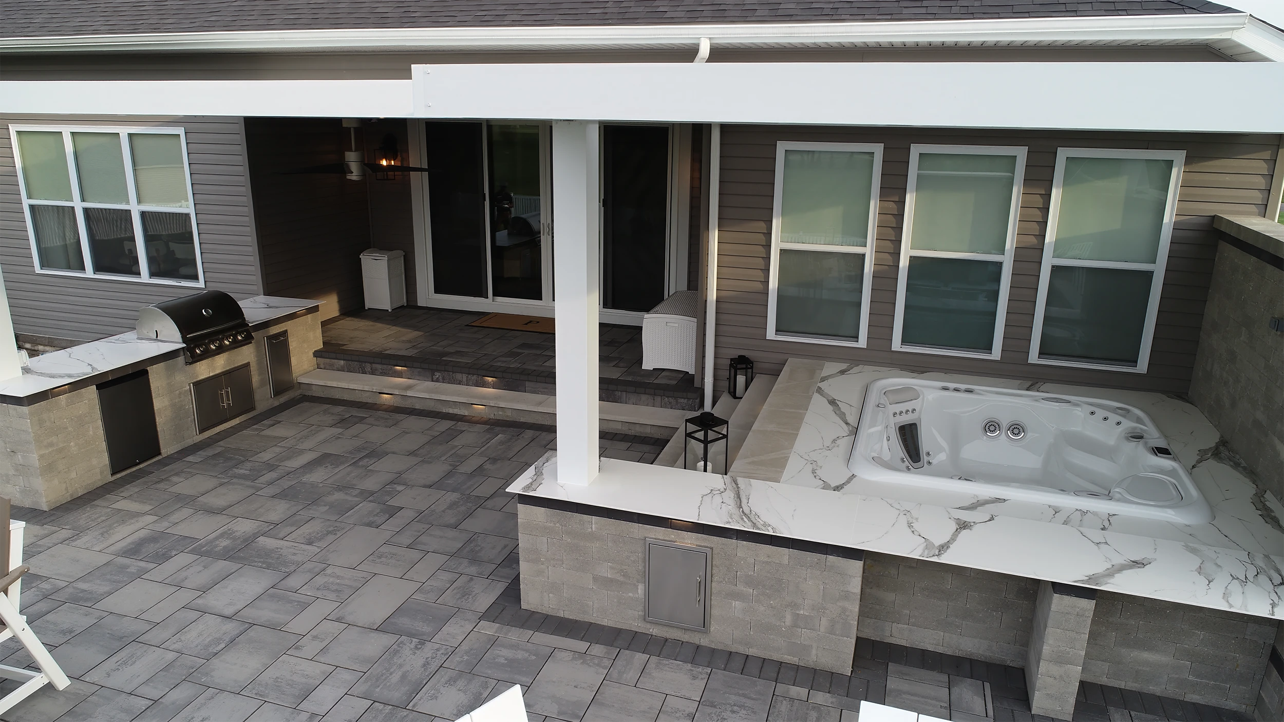 Motorized pergola covering a luxury outdoor kitchen and spa patio installed by Allscape Patio in Wadsworth, Ohio.