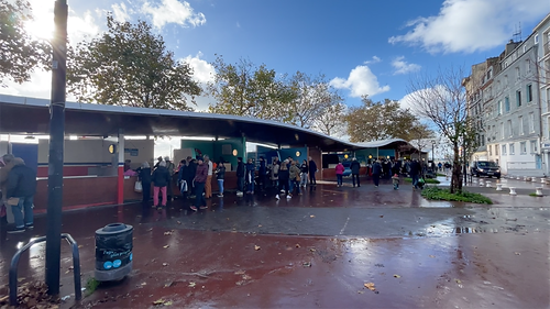 Local fishermen selling freshly caught seafood, including scallops, sole, and crab, at their colourful outdoor stalls along Quai de l'Île at the fish market in Le Havre, Normandy.