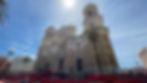 The dramatic stone façade, bell towers, and famous golden dome of Cádiz Cathedral viewed from Plaza de la Catedral in Spain.