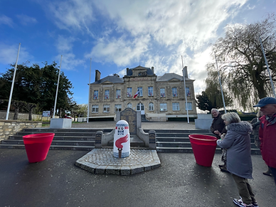 The Hôtel de Ville town hall in Sainte-Mère-Église Normandy featuring the Liberty Road Milestone 0 marker.
