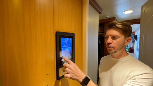 Tom using the Princess Medallion door entry system and digital screen for Do Not Disturb outside the cabin door.
