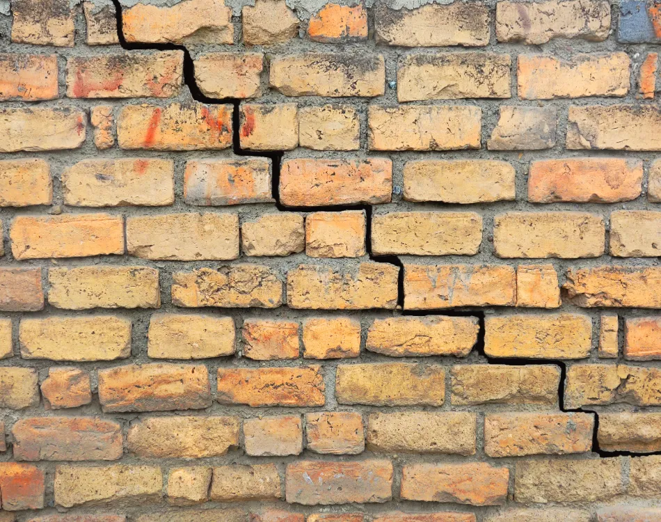 A brick exterior wall with a large crack.