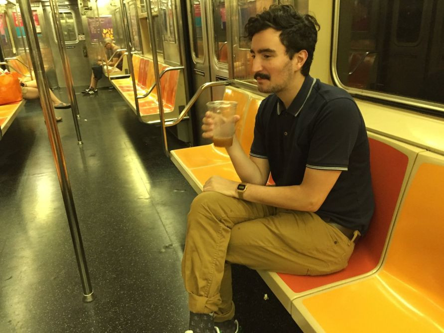 man carrying open container on nyc subway train
