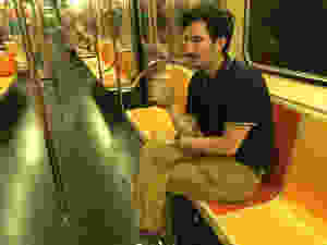 man carrying open container on nyc subway train
