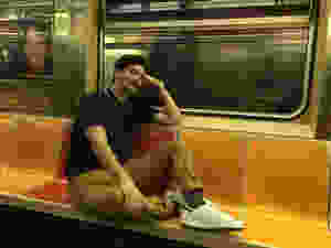 man obstructing seats on nyc subway train