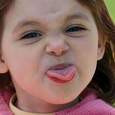 Young girl sticking her tongue out to be mean