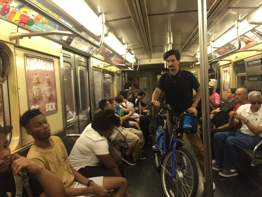 man obstructing passage with bike on nyc subway train