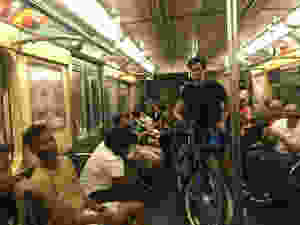man obstructing passage with bike on nyc subway train