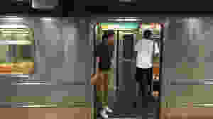 man holding doors on nyc subway train