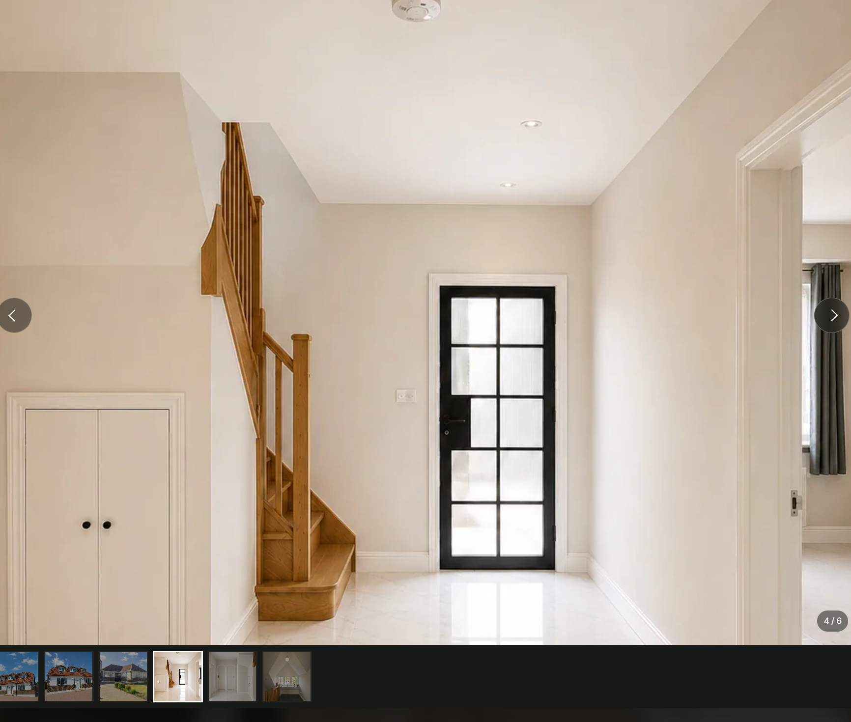 J.LEO entrance hall with oak staircase and pale stone flooring