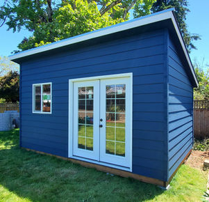 blue and white office style shed with white double doors and a white window
