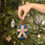 Thumbnail: Oh Snap Gingerbread Man Ornament shown near a Christmas Tree