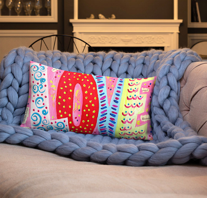 Thumbnail: love pillow front view on a blue blanket on a couch in a home