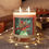 Thumbnail: Pine Cone Bouquet Holiday full glass candle in festive Christmas setting