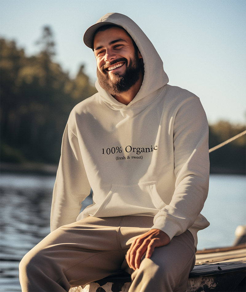100% Organic Fresh & Sweet Hoodie on a young man fishing on a dock