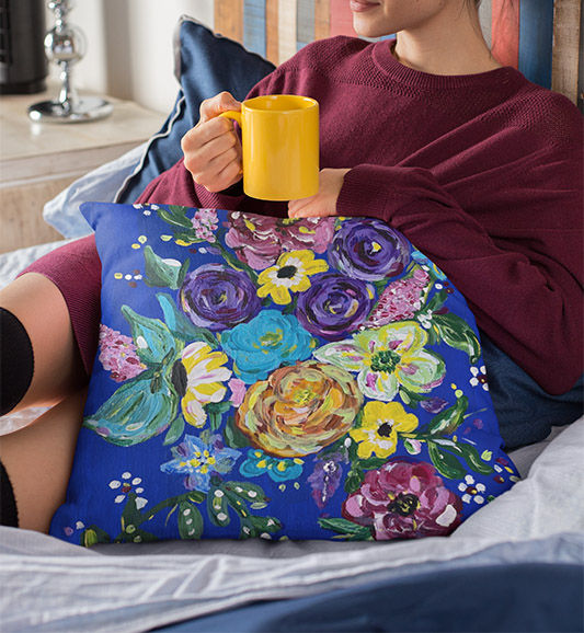 Thumbnail: Floral Sapphire Pillows cuddled by a woman on a cold day