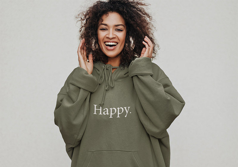 Happy Hoodie on a smiling woman with earphones listening to music and dancing