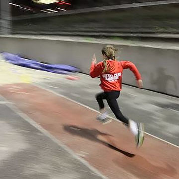 Junior member running down the long jump track