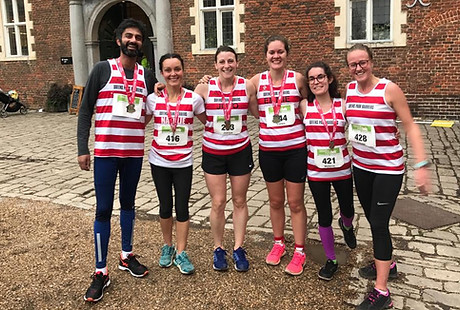 Group shot of runners wearing medals at Osterley Park