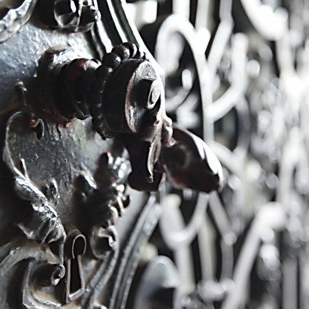 Close-up of curved metalwork with bright highlights and soft contrast in light.