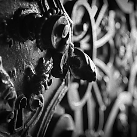 Detailed close-up of ornate metal design showing symmetry, texture, and shadow contrast.