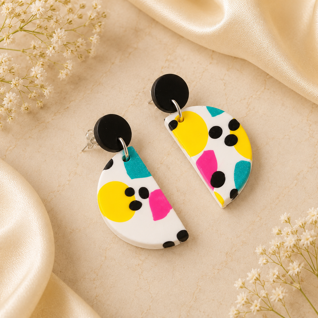 Handmade colorful polymer clay dangle earrings with abstract geometric pattern in yellow, turquoise, pink and black